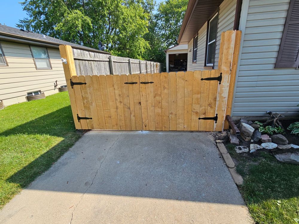 A custom cedar privacy gate with black strap hinges